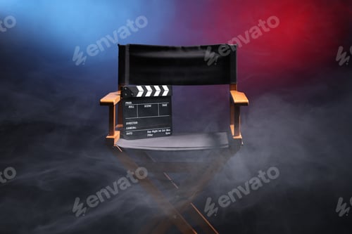 Preview: Film director's chair and clapperboard on dark background in neon lights with smoke, closeup
