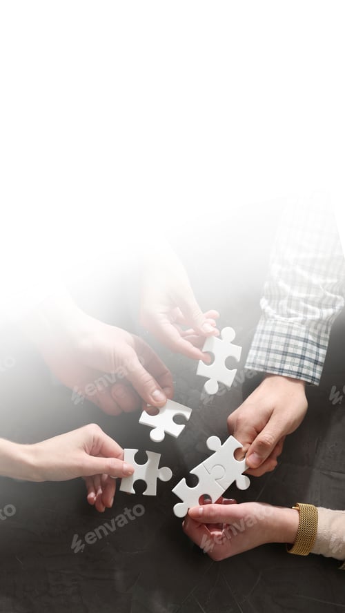 Preview: Team building. Coworkers joining puzzle pieces at table, top view. Space for text