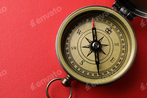 Preview: One compass on red background, top view. Space for text
