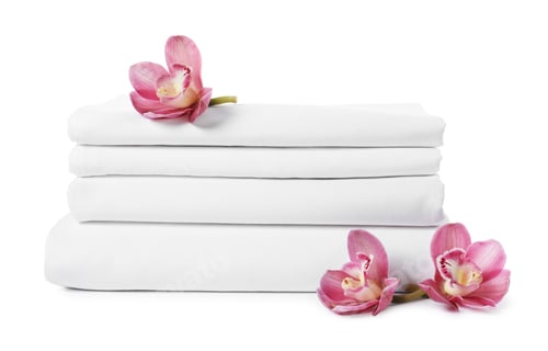 Preview: Stack of clean folded towels and orchid flowers isolated on white