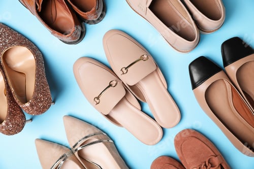Preview: Different pairs of stylish shoes on light blue background, flat lay
