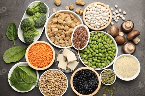 Preview: Different vegan products on grey table, flat lay. Source of protein