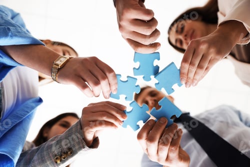 Preview: Team building. Group of businesspeople putting puzzle pieces together against blurred white backgrou