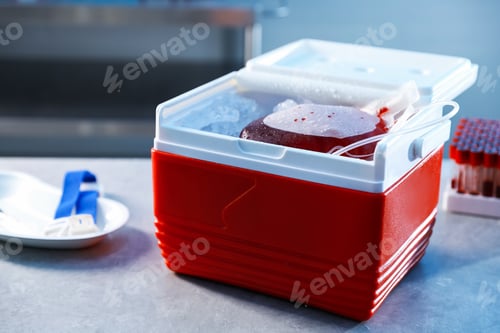 Preview: Portable medical refrigerator with bag of blood on grey table indoors