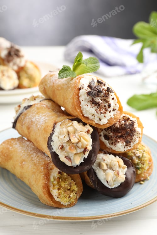 Preview: Delicious canoli with cheese, chocolate and almonds on white wooden table, closeup