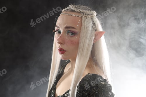 Preview: Beautiful girl dressed as elf on black background with smoke