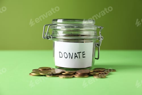 Preview: Donation jar with coins on green background, closeup