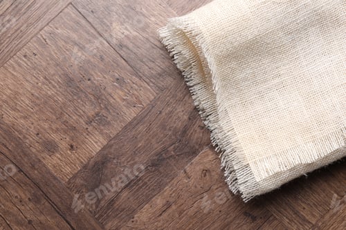 Preview: Natural burlap fabric on wooden table, top view. Space for text