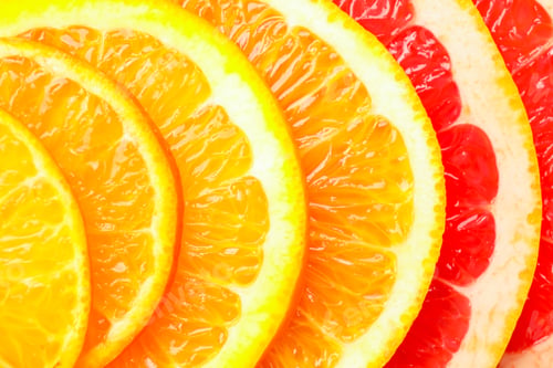 Preview: Slices of fresh citrus fruits as background, top view