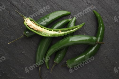 Preview: Green chili peppers on grey textured table, top view