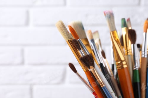 Preview: Different paintbrushes on white brick background, closeup. Space for text