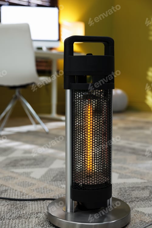 Preview: Modern portable electric heater in room, closeup. Space for text