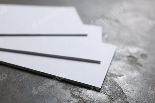 Preview: Blank business cards on grey textured background, closeup. Mockup for design