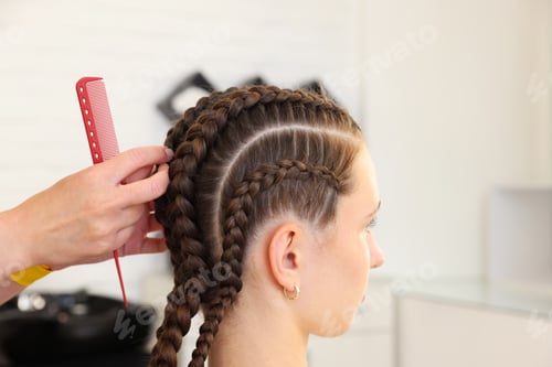 Preview: Hair braiding. Hairdresser working with teenage girl in salon, closeup