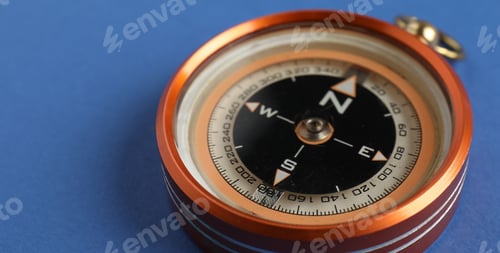Preview: One compass on blue background, closeup. Space for text