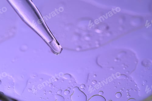 Preview: Dripping liquid from pipette on color background, closeup