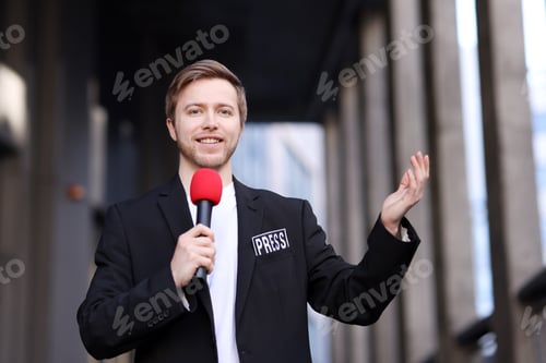 Preview: Professional journalist with microphone near building outdoors
