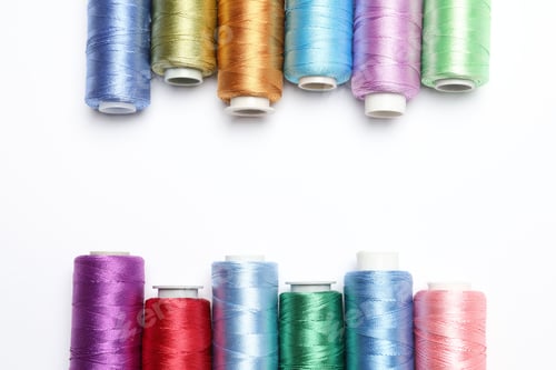 Preview: Frame made of different spools of thread on white background, flat lay. Space for text