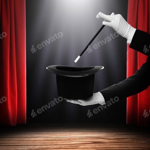 Preview: Magician performing trick with wand and top hat on stage against red curtains, closeup