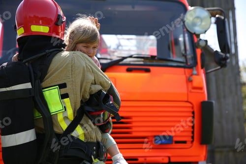 Preview: Firefighter in uniform holding rescued little girl near fire truck outdoors, space for text. Save li