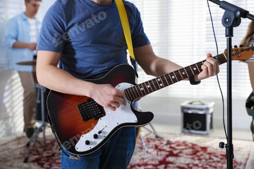 Preview: Teenage music band practicing their performance indoors, closeup