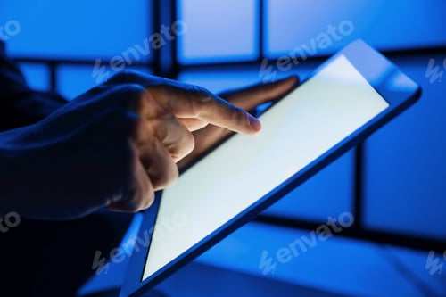 Preview: Man using modern tablet indoors, closeup view