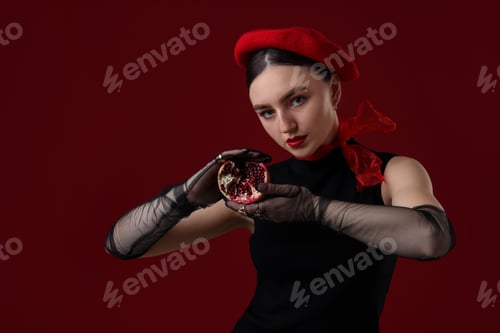 Preview: Beautiful woman with ripe pomegranate on red background. Space for text