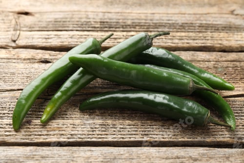 Preview: Fresh green chili peppers on wooden table, closeup