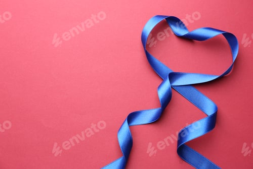 Preview: Beautiful blue ribbon on red background, top view. Space for text
