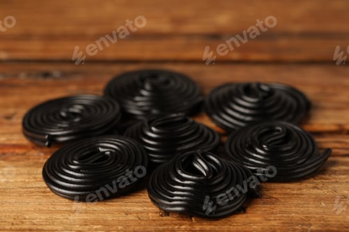 Preview: Natural licorice candies on wooden table, closeup