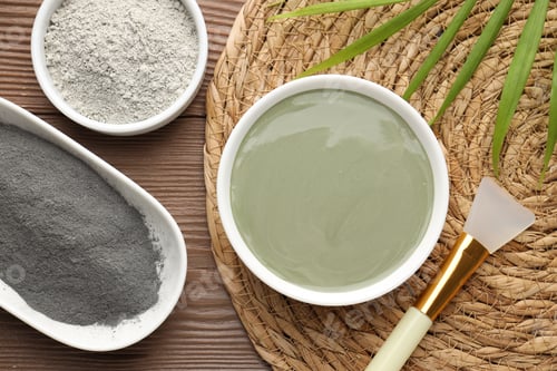 Preview: Mud therapy. Natural clay paste for facial and body care, brush, powders and green leaves on wooden