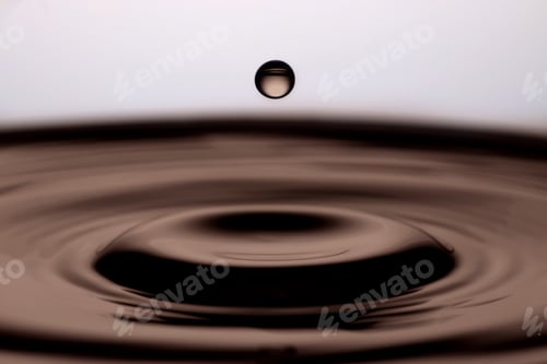 Preview: Soy sauce drop falling into liquid against white background, closeup
