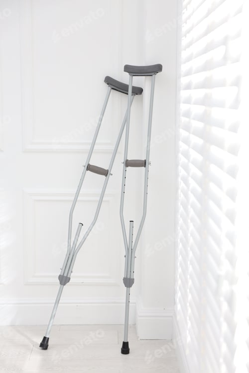 Preview: Metal axillary crutches near window indoors. Mobility aid
