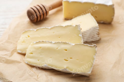 Preview: Slices of delicious brie cheese on table, closeup