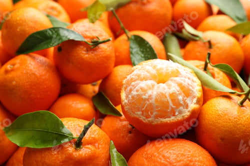Preview: Many fresh ripe tangerines with green leaves and water drops as background, closeup