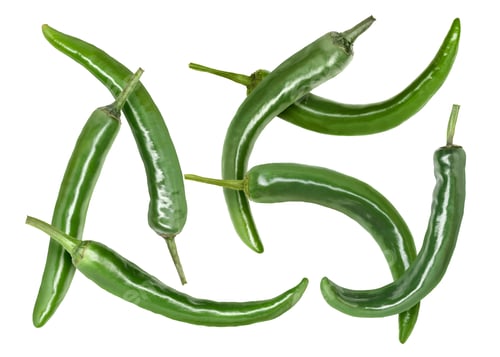 Preview: Green chili peppers flying in air on white background