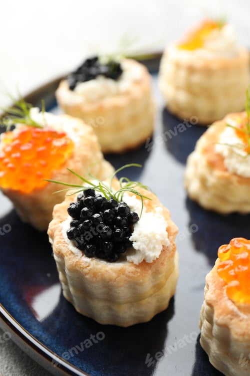 Preview: Tasty puff pastries with cream cheese, caviar and dill on table, closeup