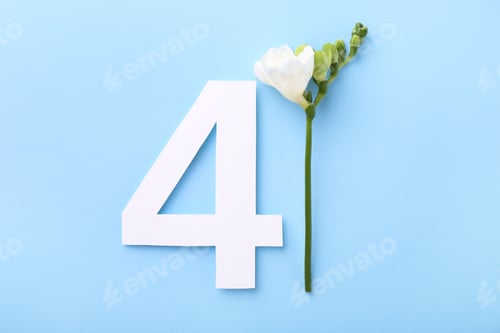 Preview: Paper number 4 and beautiful flower on light blue background, top view