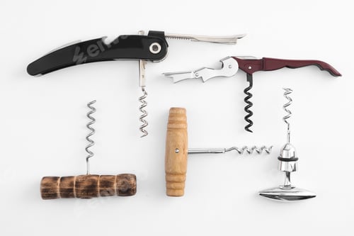Preview: Different corkscrews on white background, flat lay