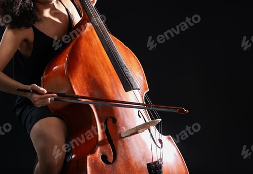 Preview: Woman playing double bass on black background, closeup. Space for text