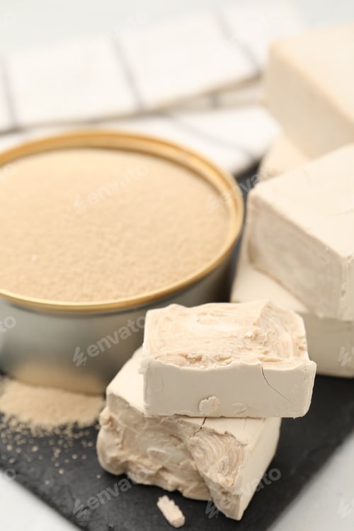Preview: Dried yeast in bowl and fresh ones on light table, closeup