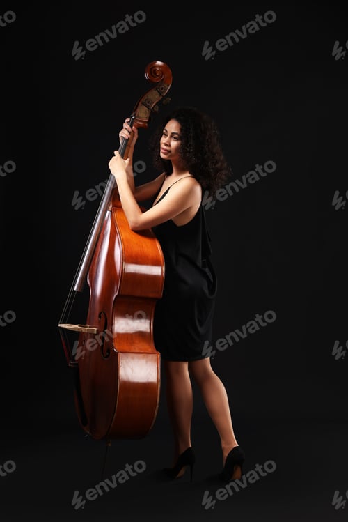 Preview: Woman with double bass on black background