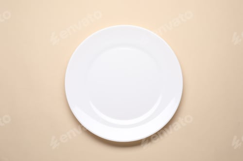 Preview: Empty plate on beige background, top view