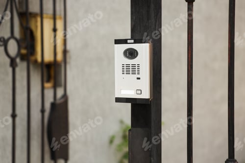 Preview: Modern intercom system on gate outdoors, closeup