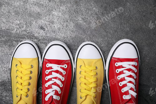Preview: Different beautiful shoes on grey textured floor, flat lay. Space for text