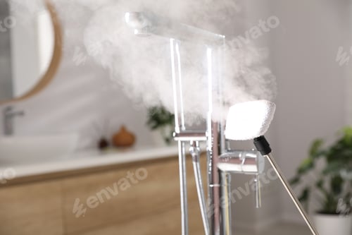 Preview: Cleaning faucet with steam cleaner in bathroom, closeup. Space for text