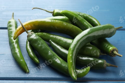 Preview: Hot green chili peppers on blue wooden table, closeup