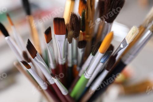 Preview: Different paint brushes on blurred background, closeup