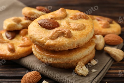 Preview: Delicious cookies with nuts on wooden table, closeup