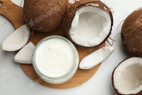 Preview: Tasty coconut yogurt in jar and fruits on white table, flat lay